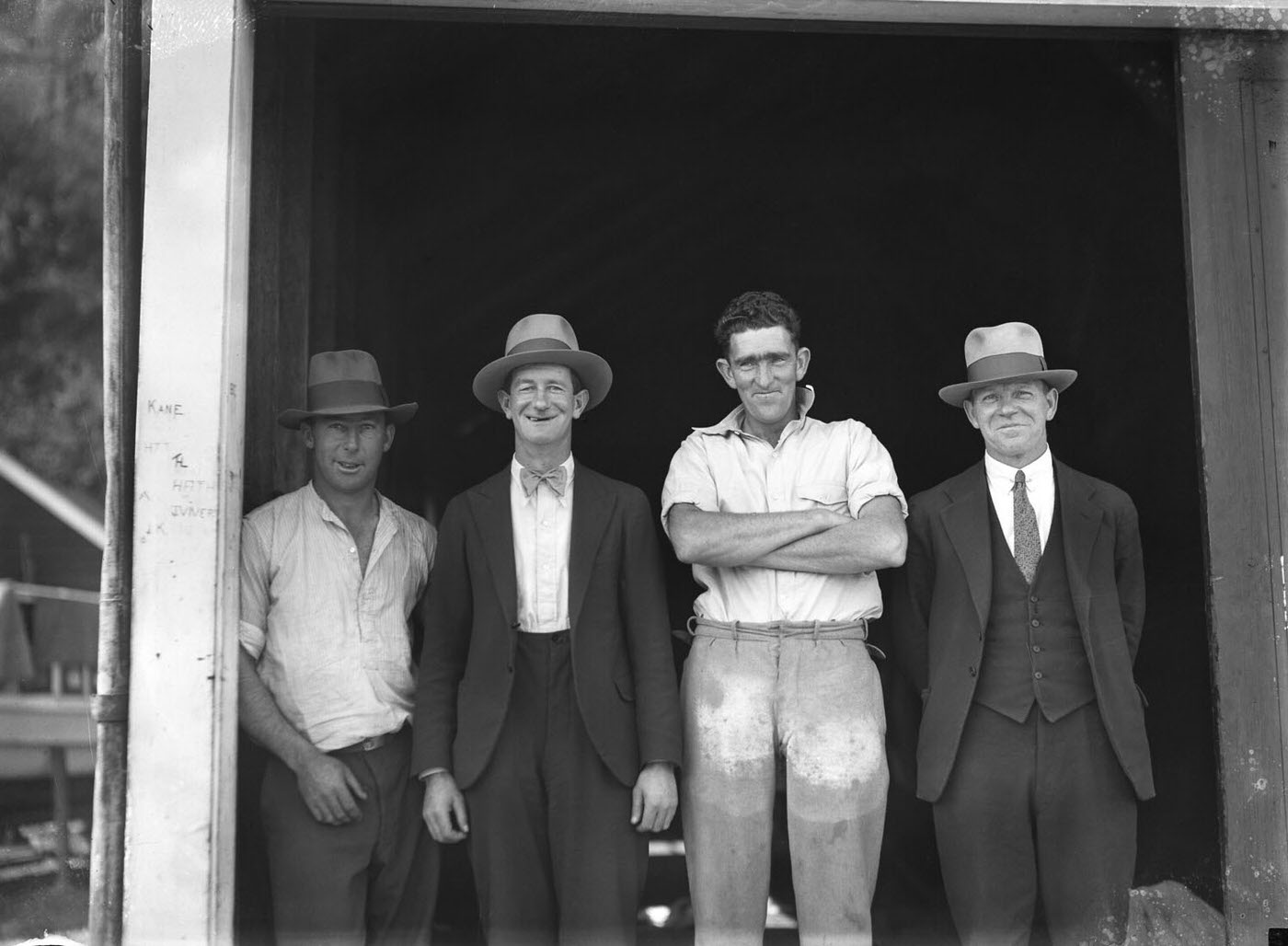 Four men outside SCEGS boatshed, Berrys Bay