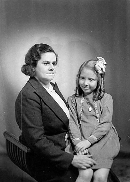 Portrait of a woman with a young girl on her lap