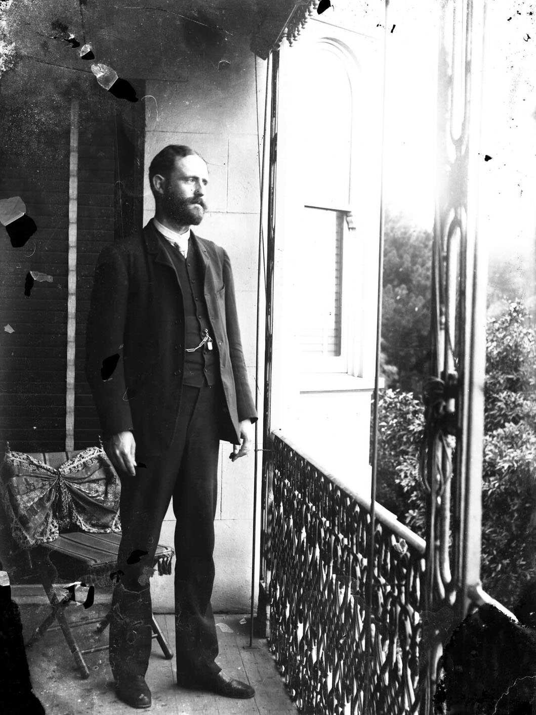 Portrait of a man standing on a verandah