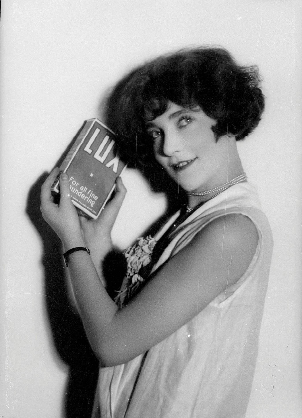 Portrait of a woman holding a box of Lux laundry powder