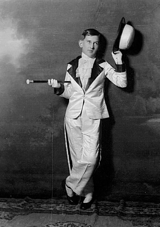 Portrait of a young man with bowler hat and cane