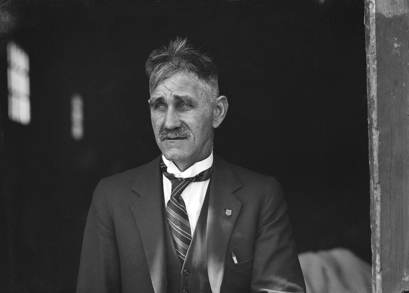 Portrait of a man outside SCEGS Boatshed, Berrys Bay