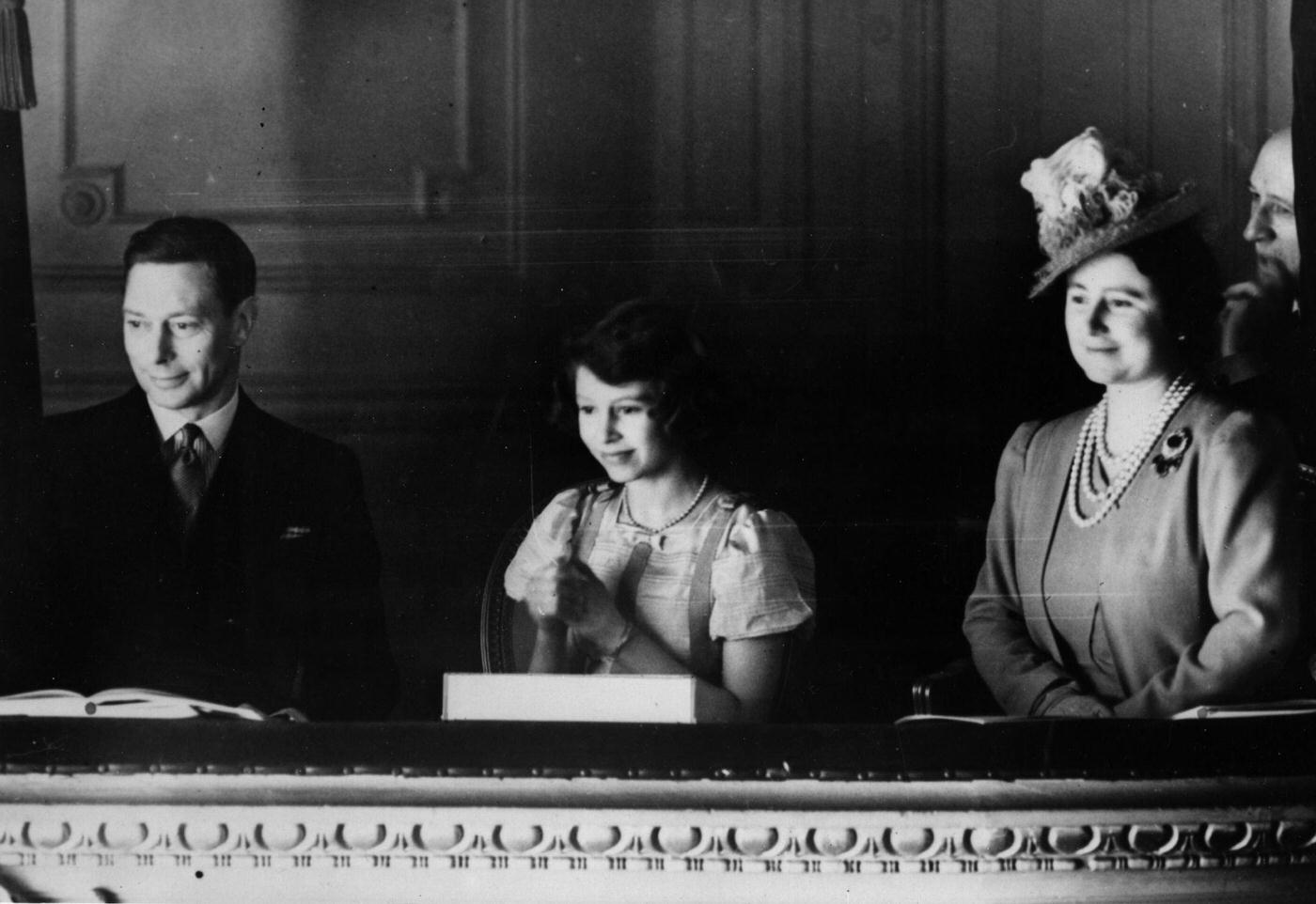 King George VI and Queen Elizabeth watching a performance from a box with Princess Elizabeth at the Coliseum Theatre, London, March 28th, 1939.