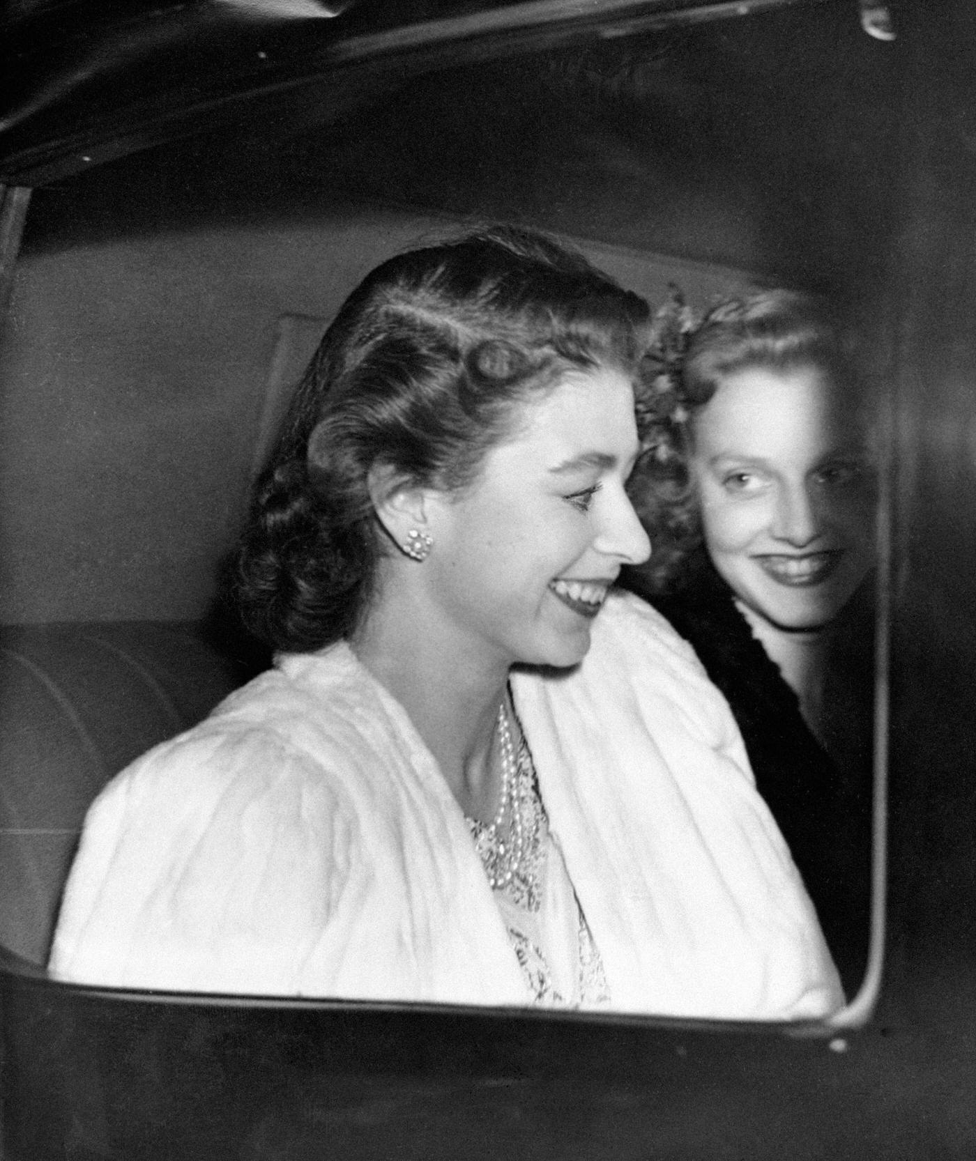 Princess Elizabeth driving from Buckingham Palace, the day before the announcement by the King of the engagement of Princess Elizabeth and Lieutenant Philip Mountbatten, London, England, 1947.