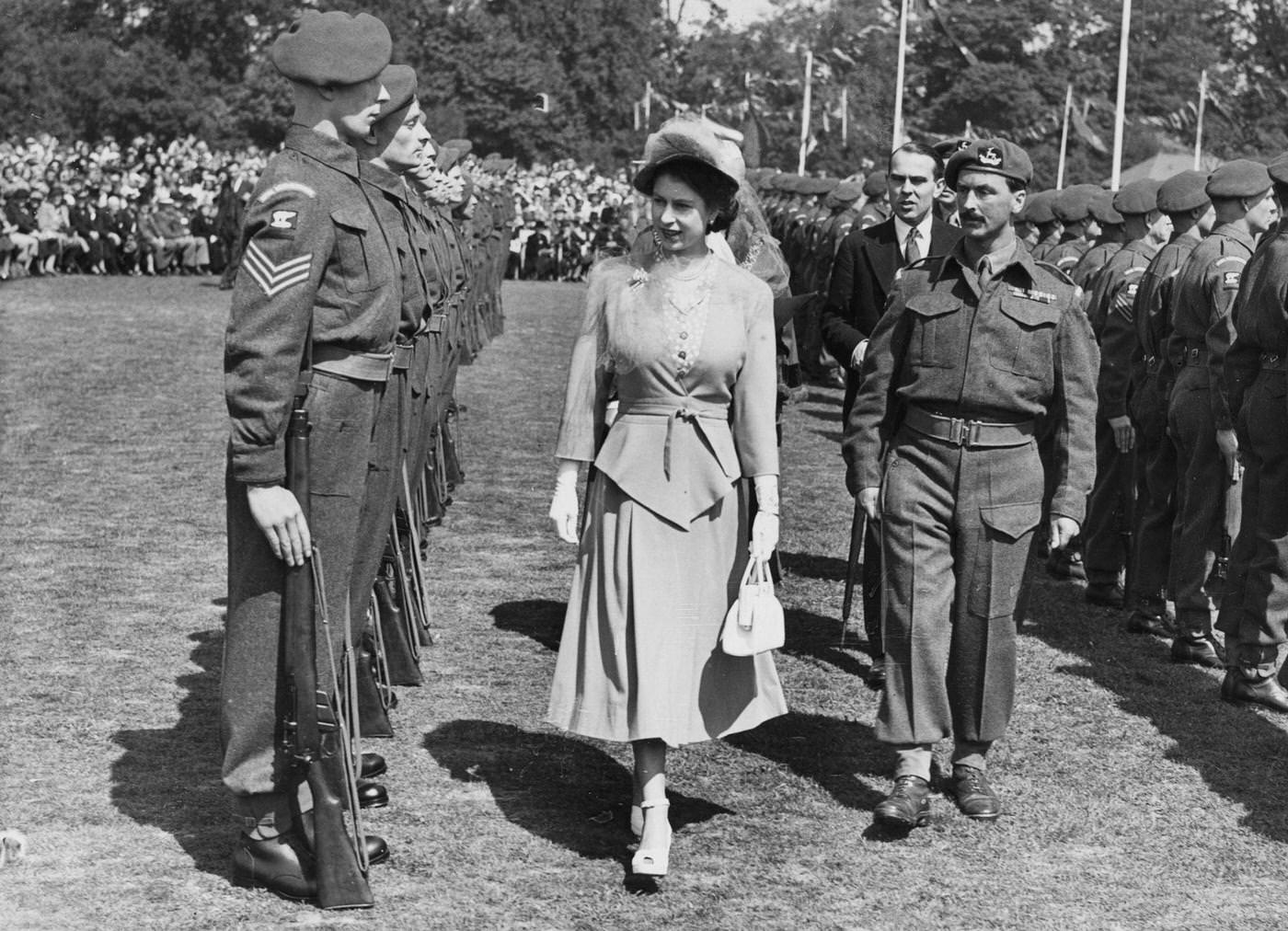 Princess Elizabeth inspects a Guard of Honor of the 7th Battalion, Royal Warwickshire Regiment at the War Memorial Park in Coventry, England, 22 May 1948.