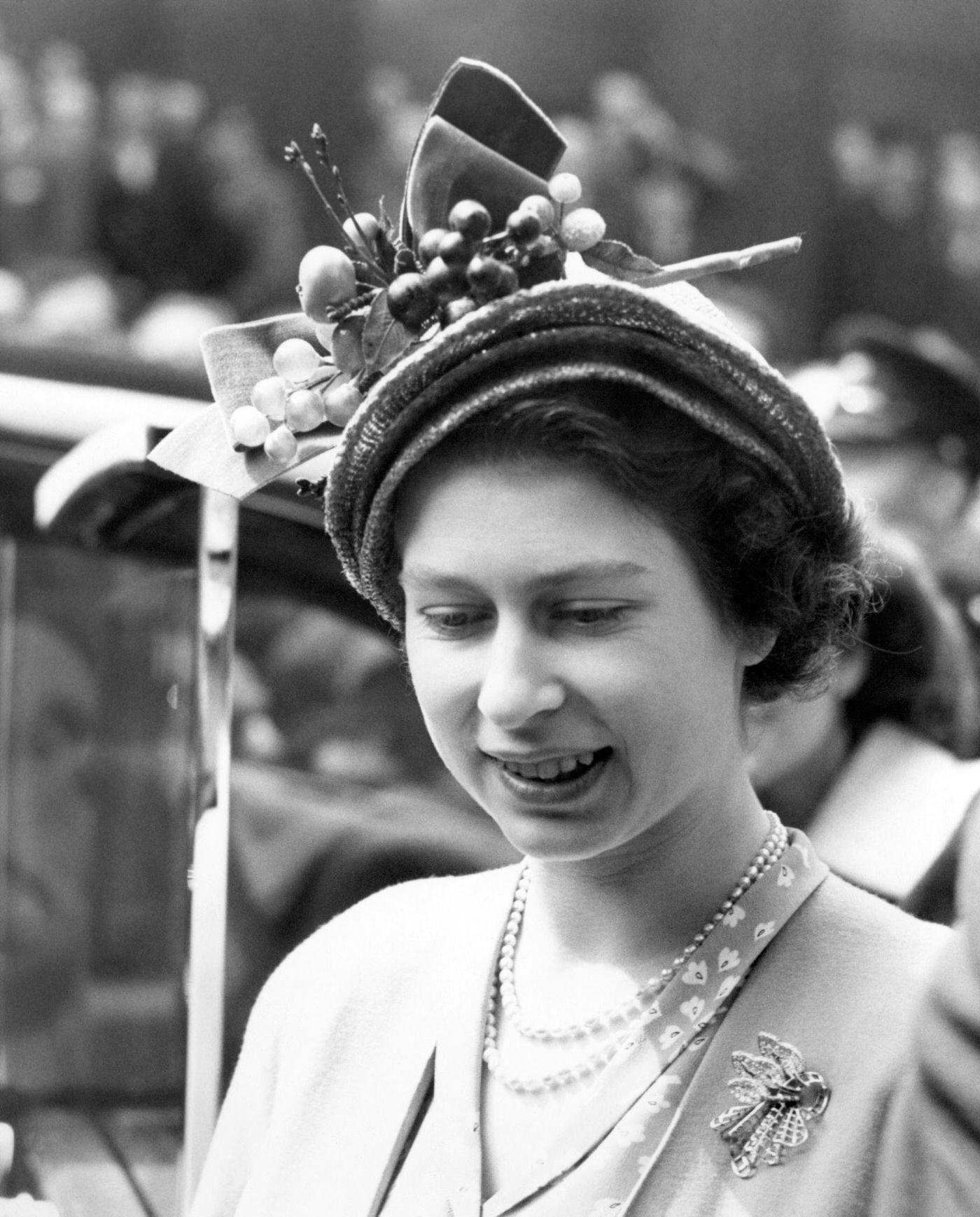 Princess Elizabeth leaves the London Stock Exchange after her private visit with the Duke of Edinburgh, where they watched business being done and lunched with the Chairman and Council, London, England, 1949.