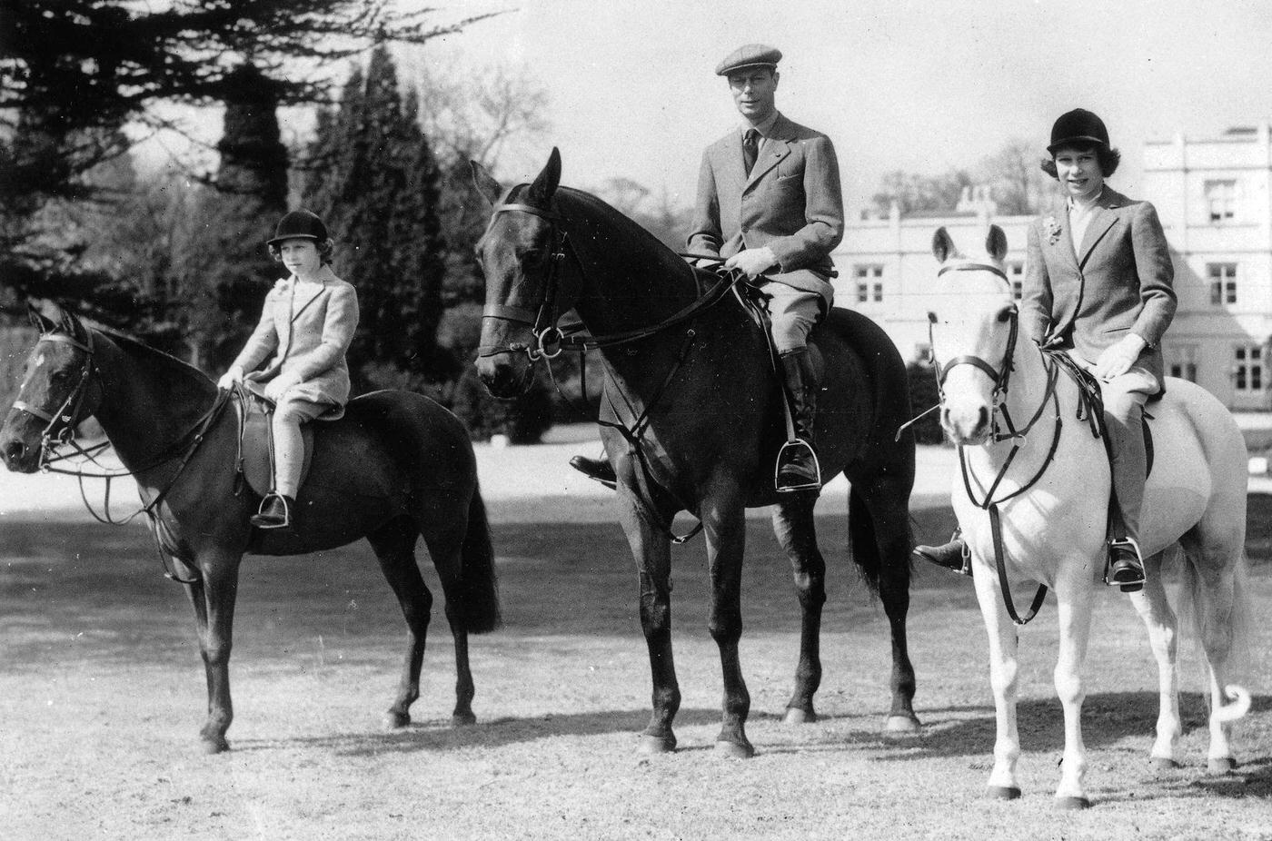 King George VI out riding his horse with his daughters Princess Elizabeth, later Queen Elizabeth II, and Princess Margaret (left) in Windsor Great Park, England, 21st April, 1939.