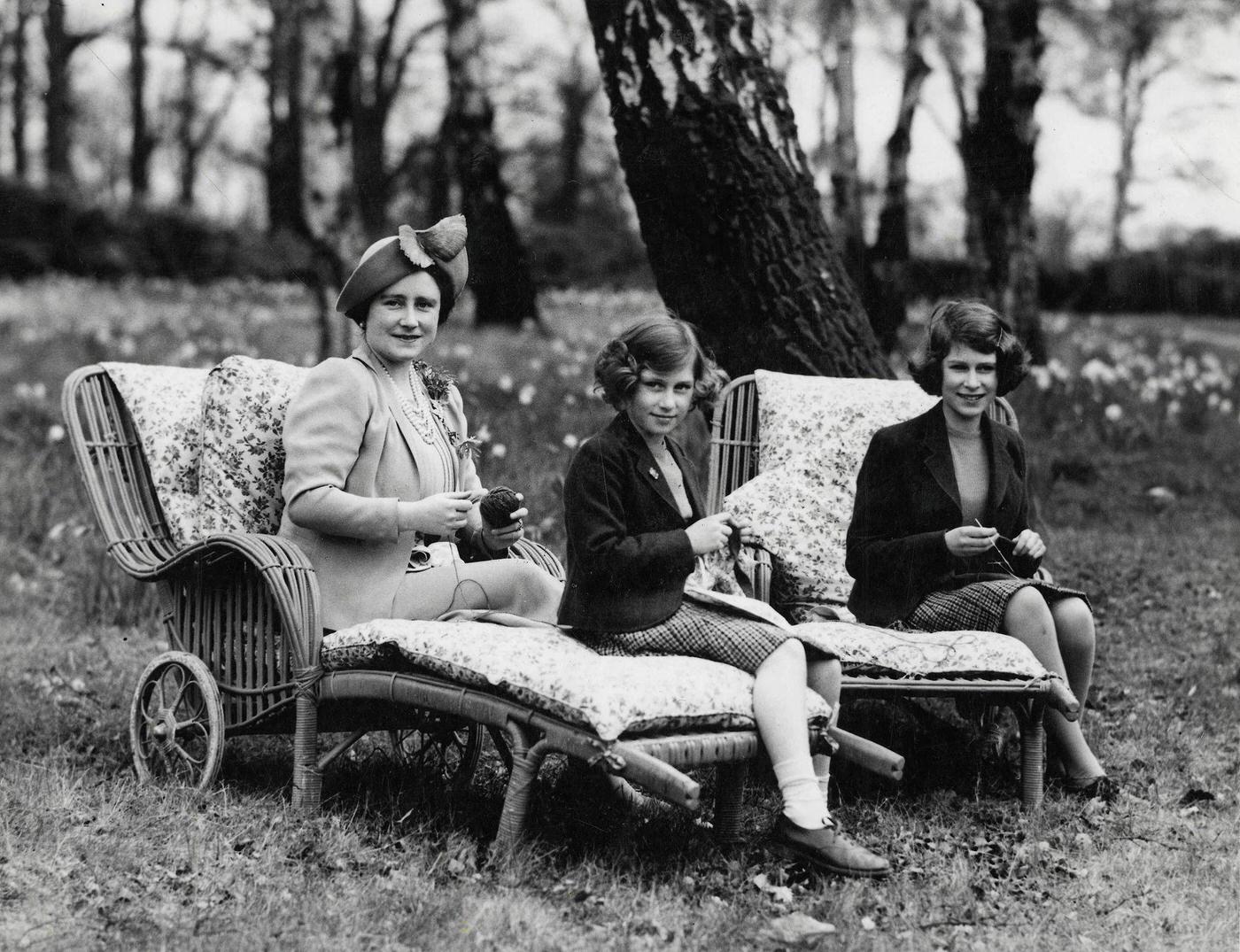 Queen Elizabeth with Princess Elizabeth and Princess Margaret as they knit for war charities during World War Two, 1940.