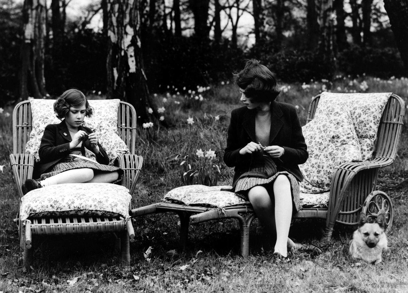 Princess Elizabeth and Princess Margaret practicing their knitting skills in the grounds of the Royal Lodge in Windsor during World War II, Windsor, England, 1940.