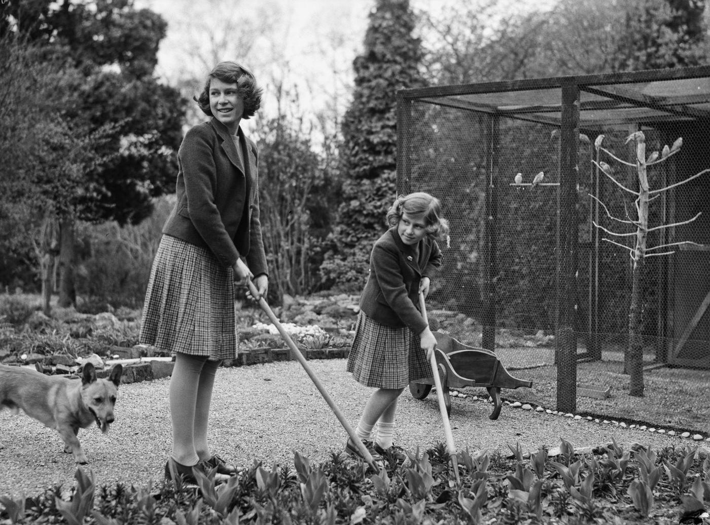 The Royal Princesses Elizabeth and Margaret with a Pembroke Welsh Corgi dog in their garden at the Royal Lodge in Windsor Great Park, UK, April 1940.