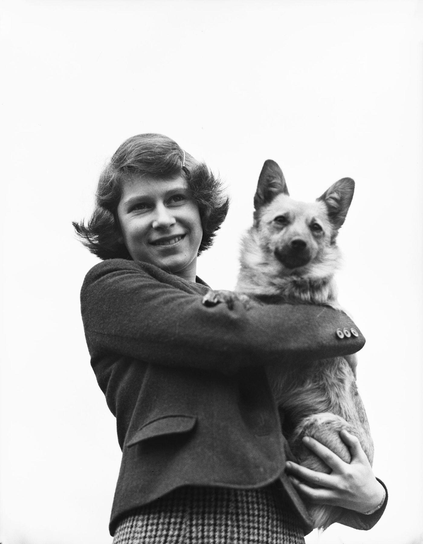 The Royal Princess Elizabeth holding a Pembroke Welsh Corgi dog, UK, April 1940.