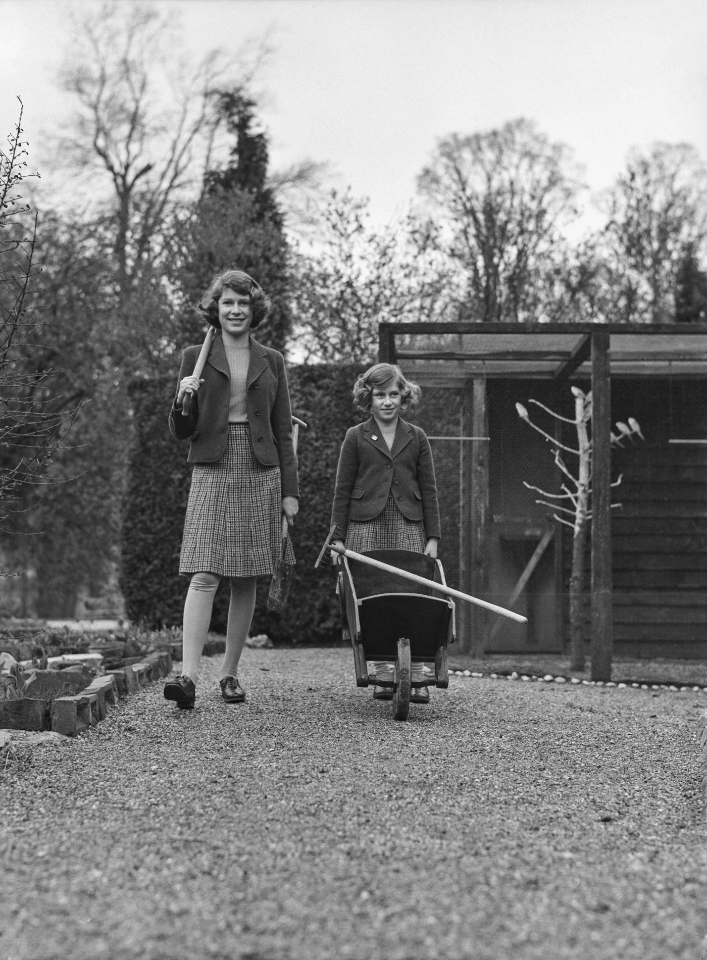 The Royal Princesses Elizabeth and Margaret in their garden at the Royal Lodge in Windsor Great Park, UK, April 1940.