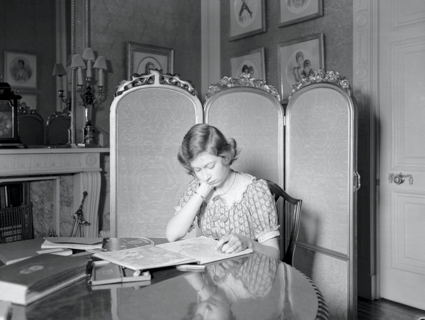 Princess Elizabeth at a desk with books at Windsor Castle, Berkshire, Great Britain, 22nd June 1940.