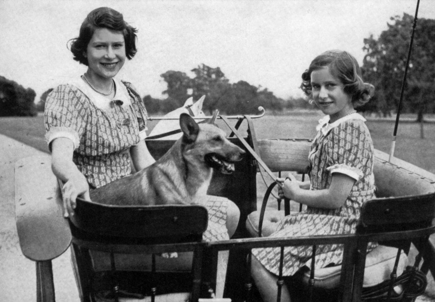 Princess Elizabeth of England (future queen Elizabeth II) and her sister princess Margaret in gradens of Windsor, 1941