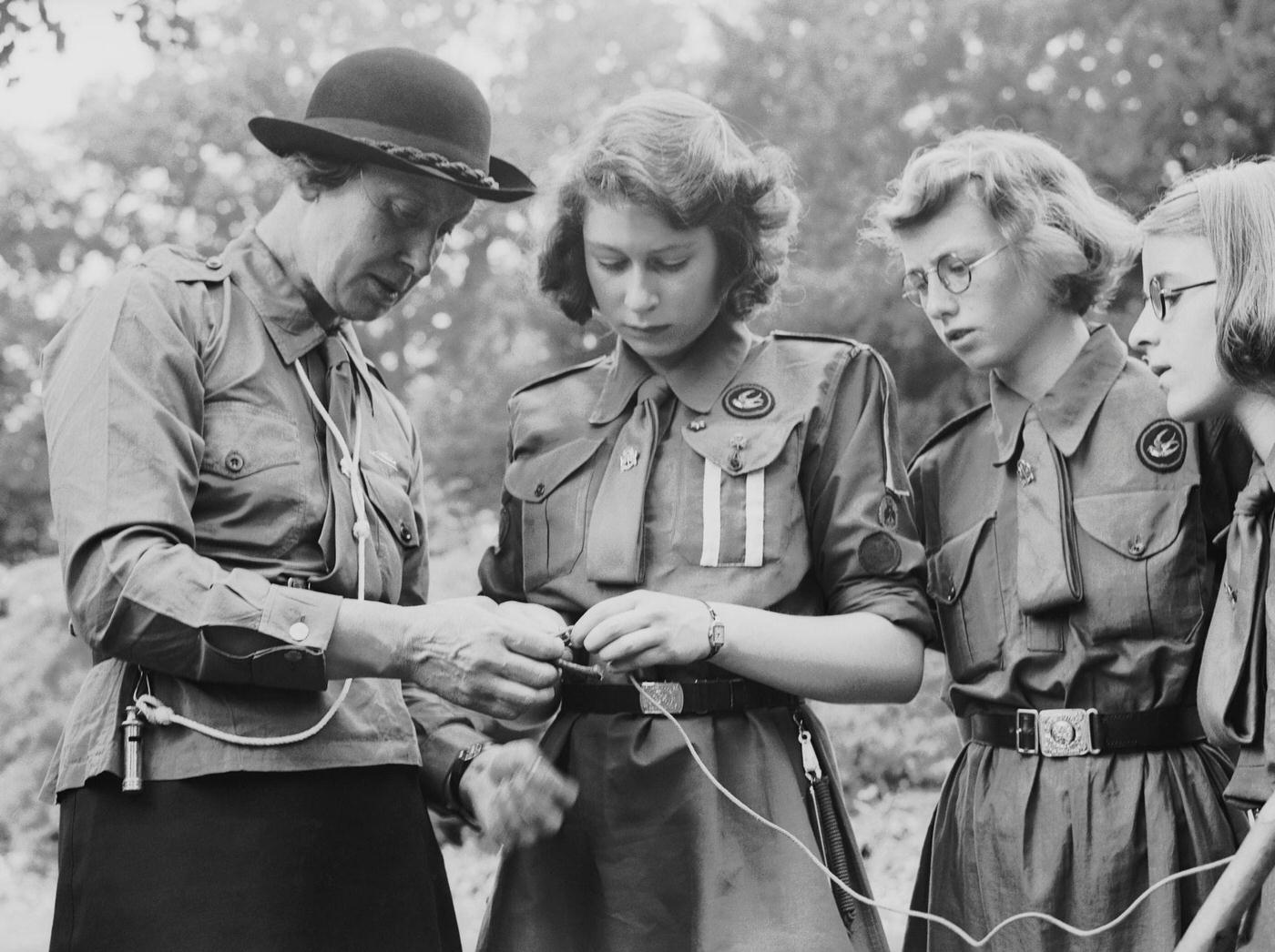 Princess Elizabeth learns to tie a knot with the girl guides in Frogmore, Windsor, England on April 11, 1942.