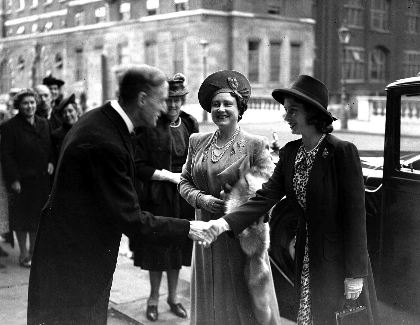 Queen Elizabeth I (Queen Mother) and Princess Elizabeth II received at the Royal College of Music by Sir George Dyson, 1943