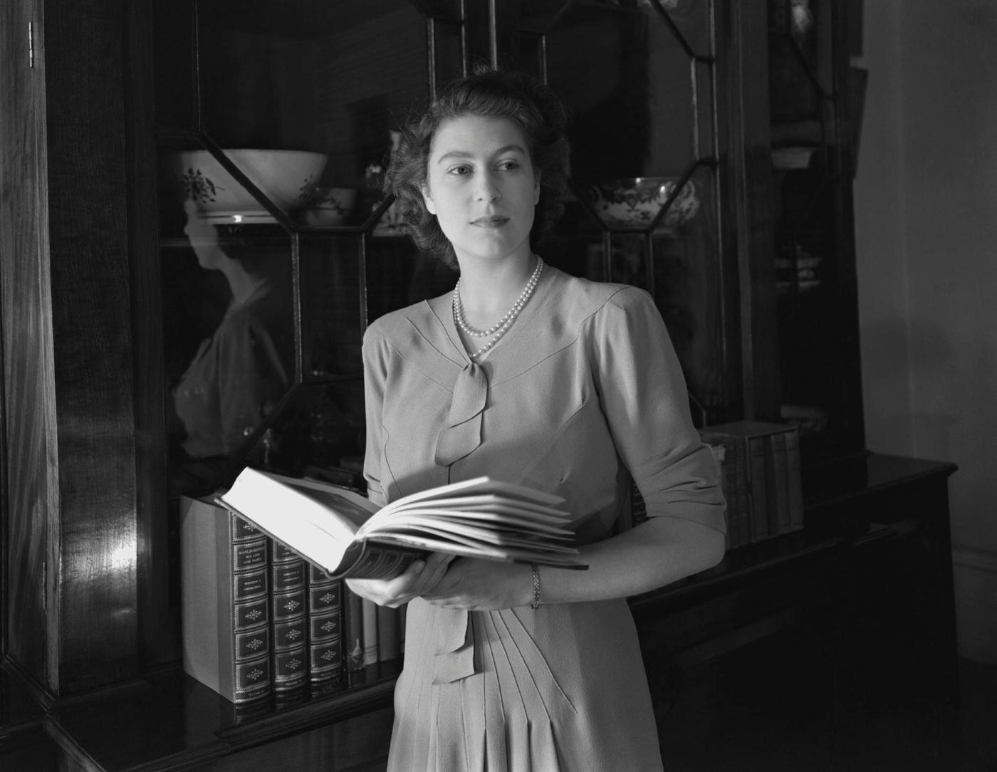 Princess Elizabeth (Queen Elizabeth II) holding a book at Windsor Castle, Great Britain, 8 July 1946.