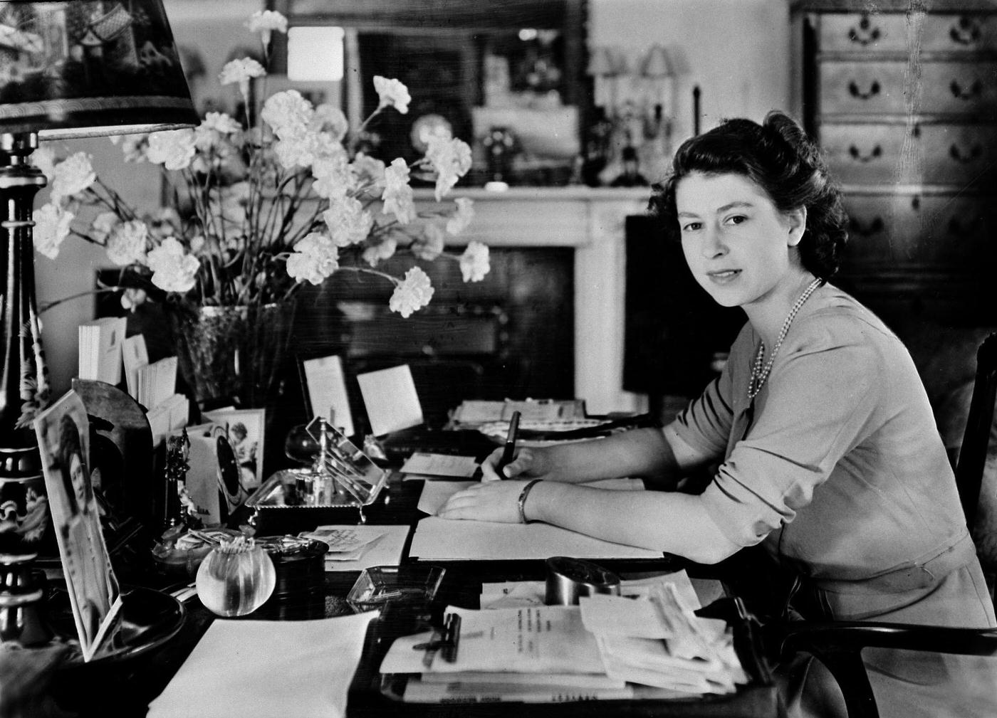 Princess Elizabeth pictured at the desk in her sitting room at Buckingham Palace, London, England, circa 1947.