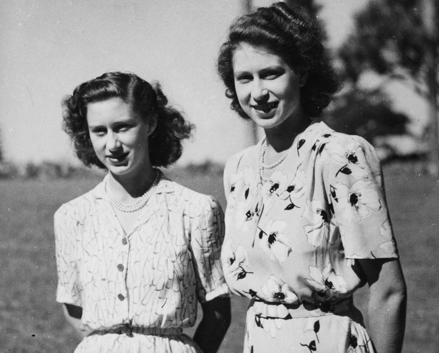 Princess Elizabeth and Princess Margaret pictured standing together in the grounds of Government House in Bloemfontein during the Royal tour of South Africa, March 1947.