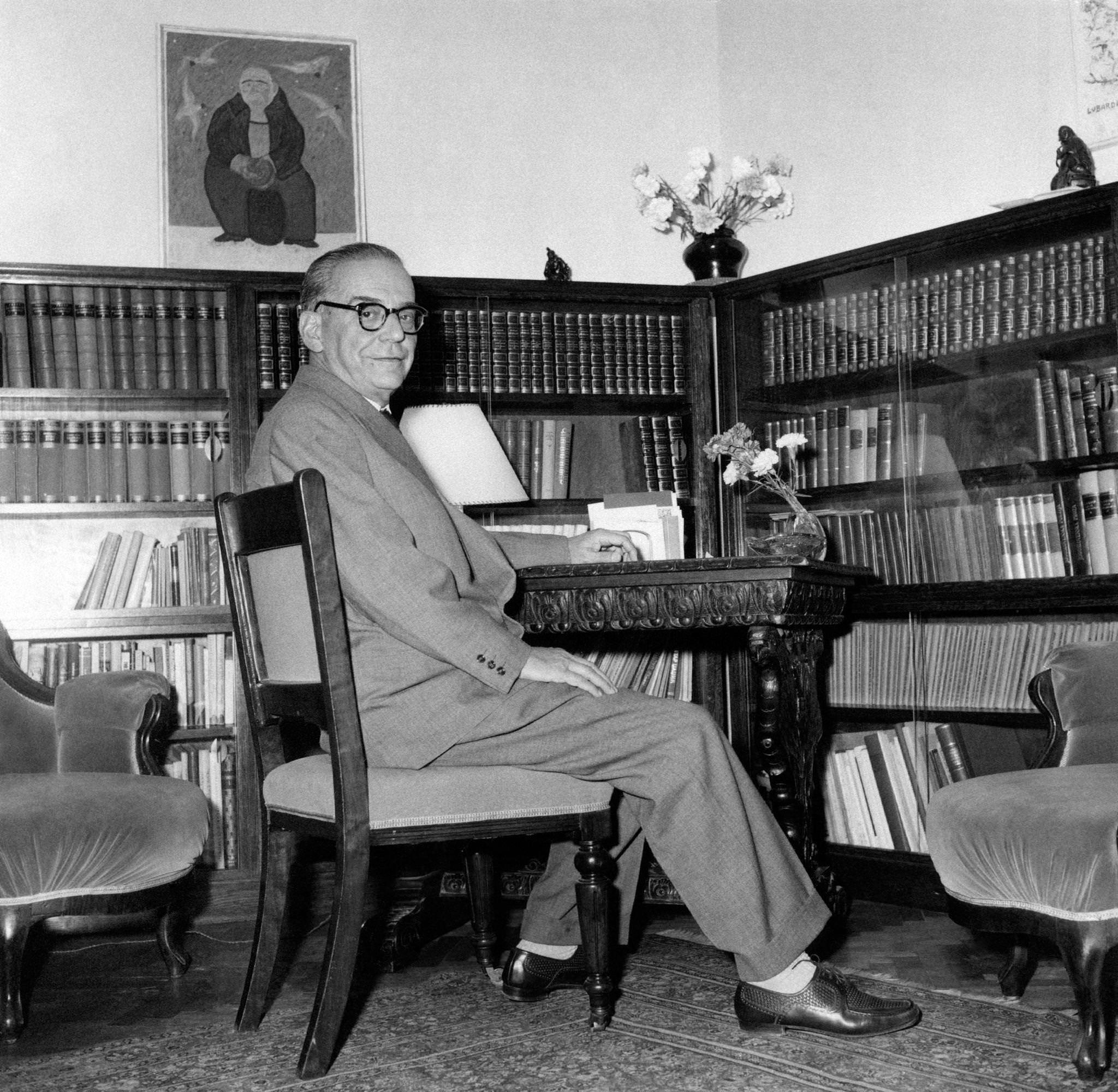 Jugoslavian writer and diplomat Ivo Andric posing sitting at the desk, 1961
