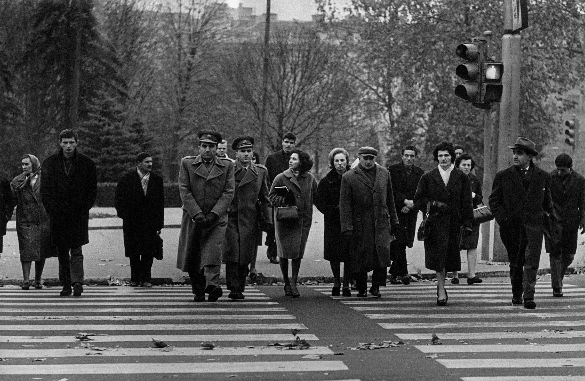 People wearing warm overcoats cross the pedestrian crossing in the city of Belgrade. Belgrade (Yugoslavia), 1965