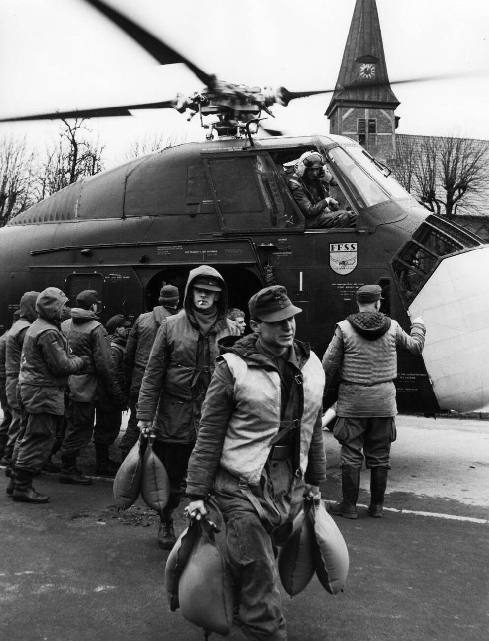 Sandbags being unloaded from a helicopter during the North Sea Flood of 1962 in Hamburg, West Germany