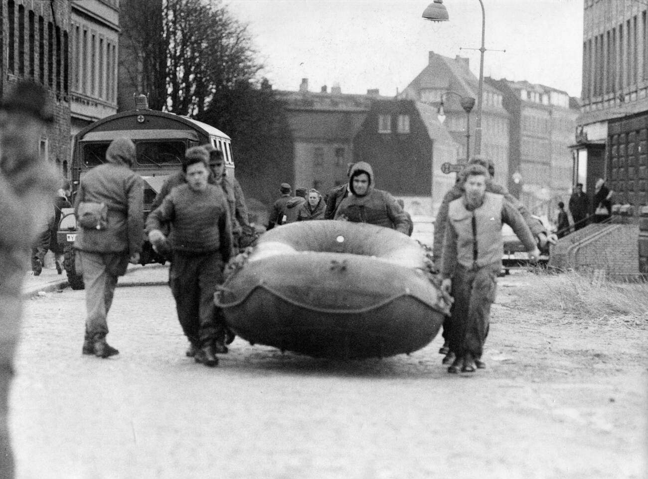 Aids of Civil Defence with an inflatable boat during the North Sea Flood of 1962 in Hamburg, West Germany