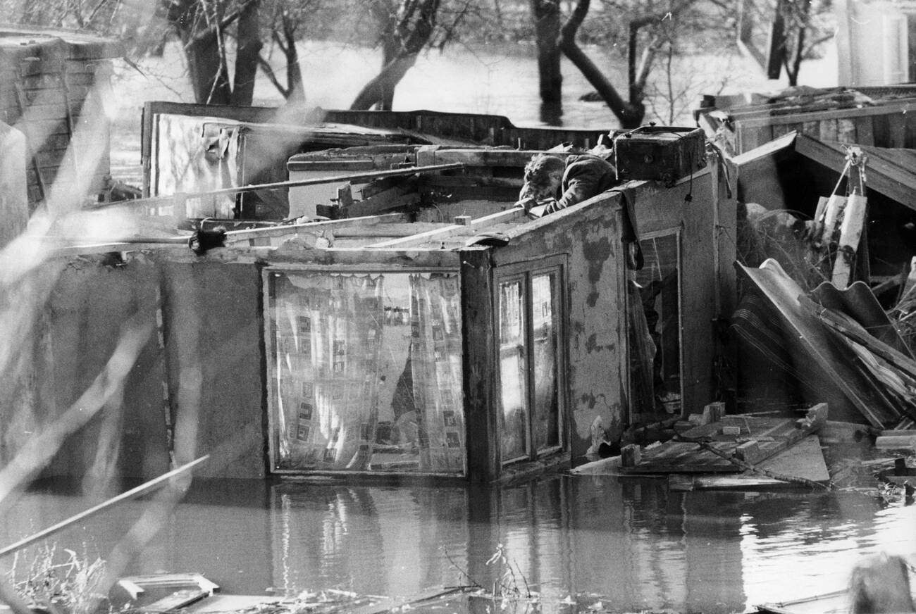 Boy searching his parents' house for useful items after the North Sea flood of 1962 in Hamburg, West Germany