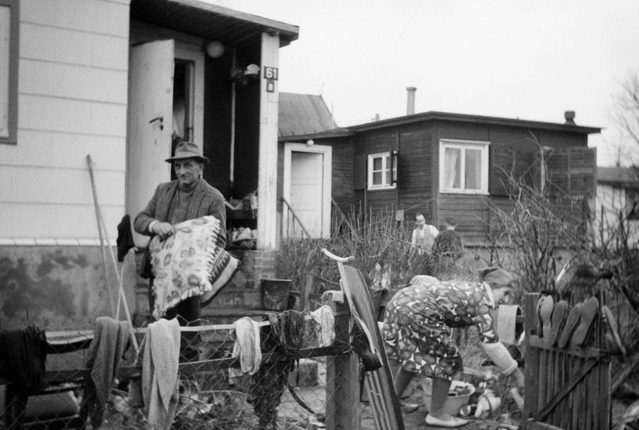 Couple standing in front of their destroyed house at Overhaken, Kirchenwerder after the North Sea flood of 1962 in Hamburg, West Germany