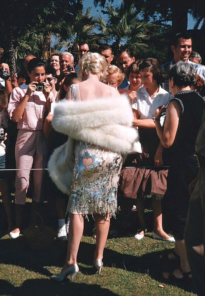 Marilyn Monroe signing autographs for fans on the set of Some Like It Hot in Coronado Beach, California, summer of 1958. Photo by Richard Miller