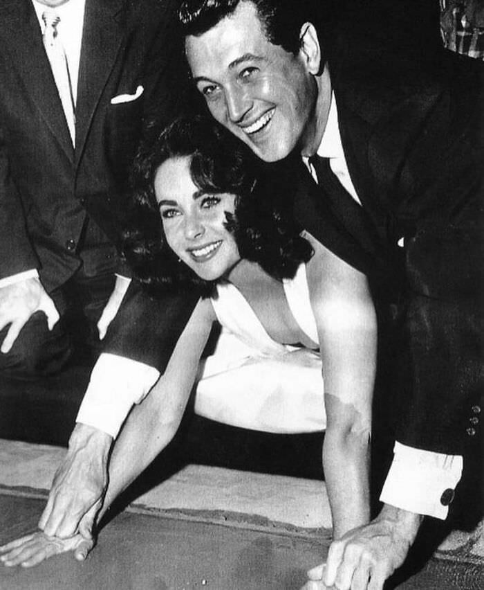 Liz Taylor and Rock Hudson cementing their handprints at the Grauman's Chinese Theatre