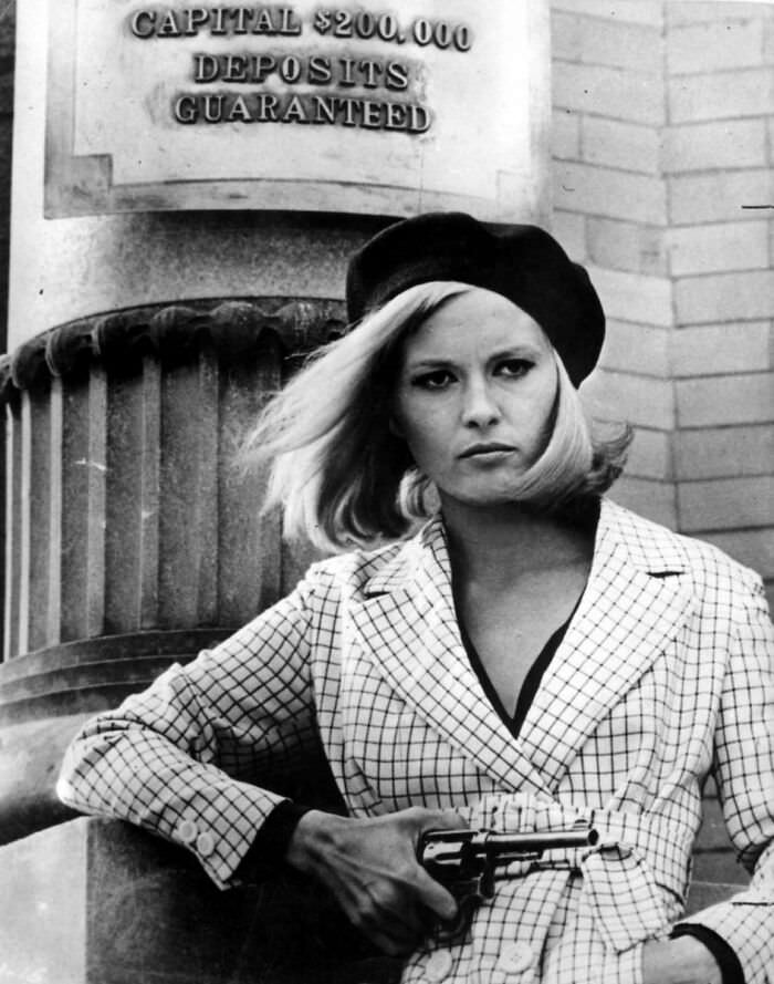 Actress Faye Dunaway as Bonnie Parker, standing outside the Merchants Bank in the film 'Bonnie and Clyde', 1967