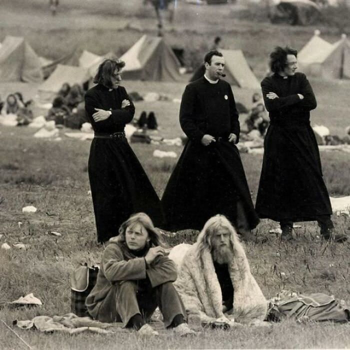 Priests mingle with hippies at the Glastonbury Music Festival in 1971