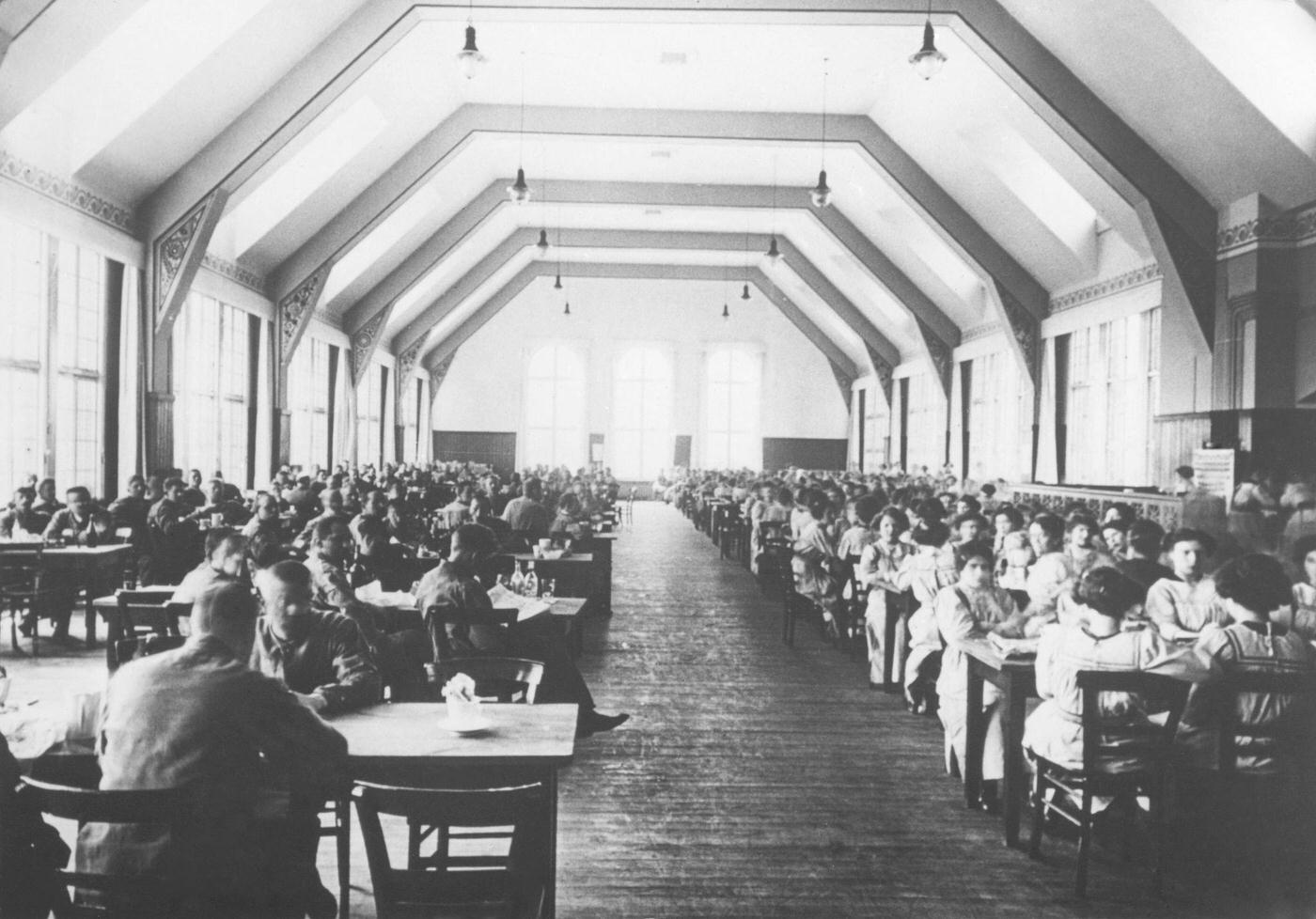 The dining room of the Verlagsgesellschaft deutscher Konsumvereine in Hamburg, Germany, with men and women sitting separately, date unknown