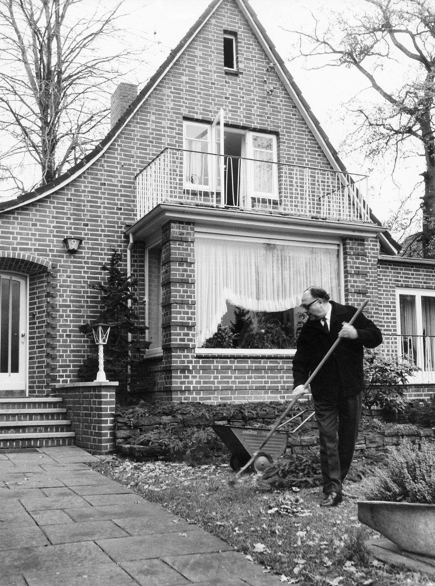Heinz Erhardt, a German actor and comedian, raking leaves in his garden in Hamburg-Wellingsbuettel, Germany in 1970.