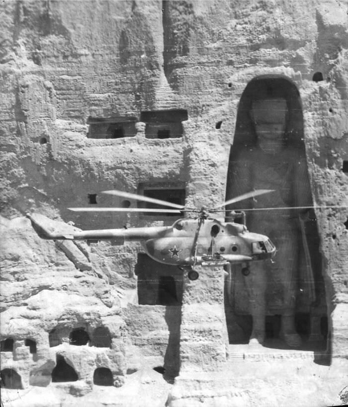 Soviet helicopter flies past the Buddha of Bamiyan