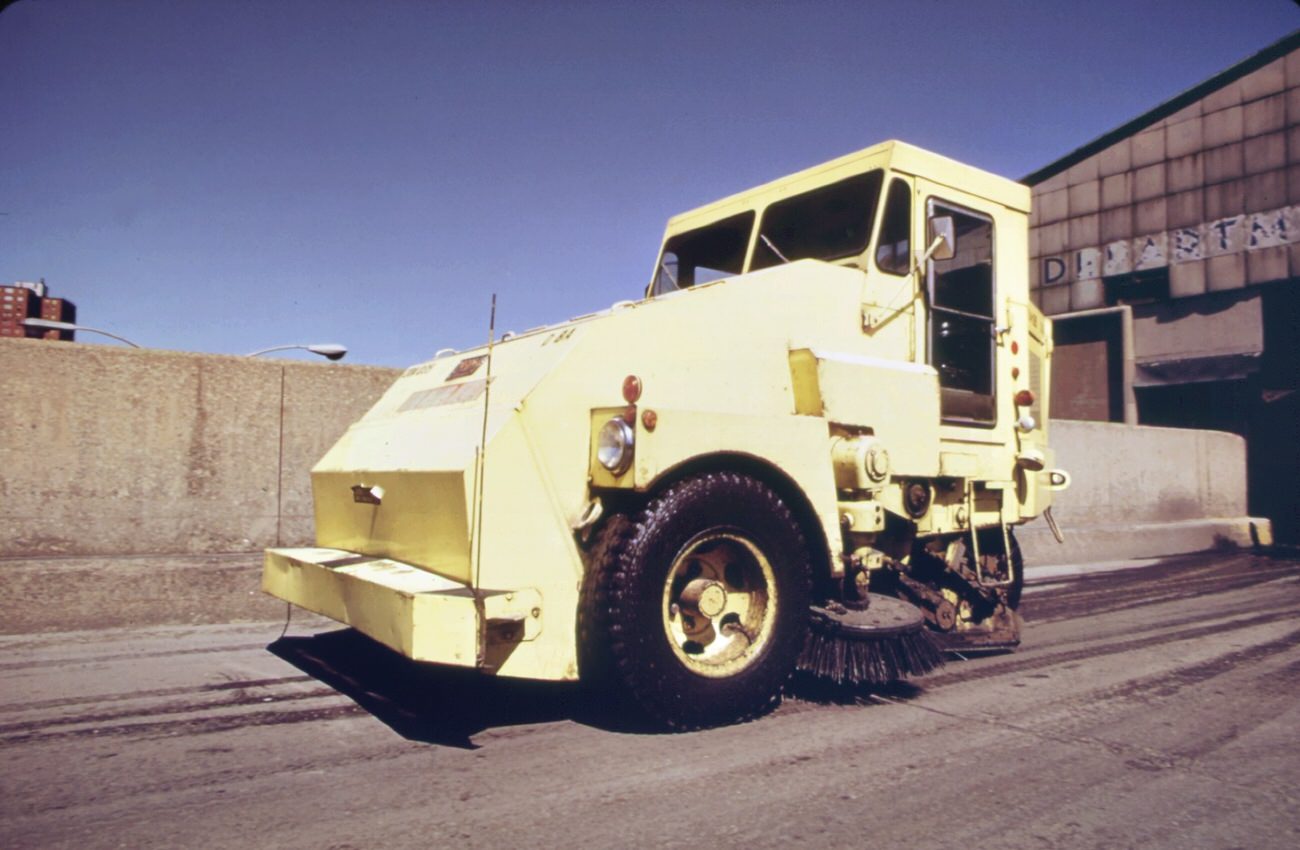 Garbage truck at the 91st street marine transfer station (mts). From the mts, garbage is carried by barge down the east river to the landfill dump on staten island, 1970s