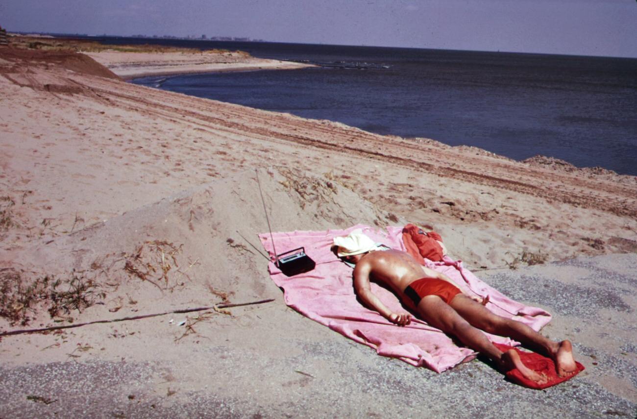 Lifeguard takes a sunbath at great kills park on staten island, 1970s