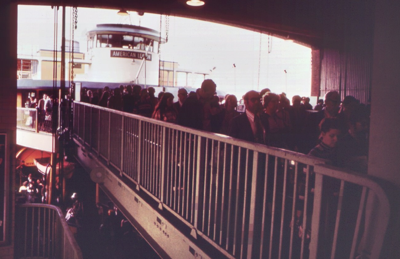 Commuters at the staten island ferry terminal in lower manhattan's battery park area, 1970s