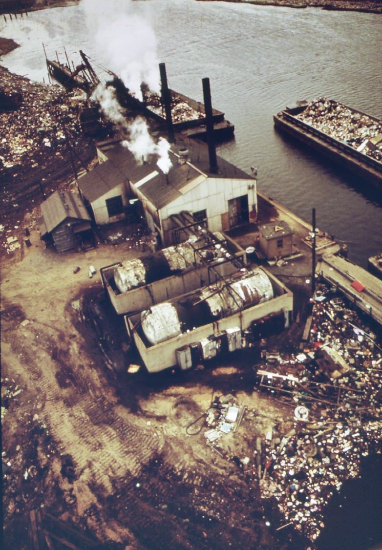 Docks at fresh kills on staten island. Scows are laden with solid waste for use as landfill, 1970s