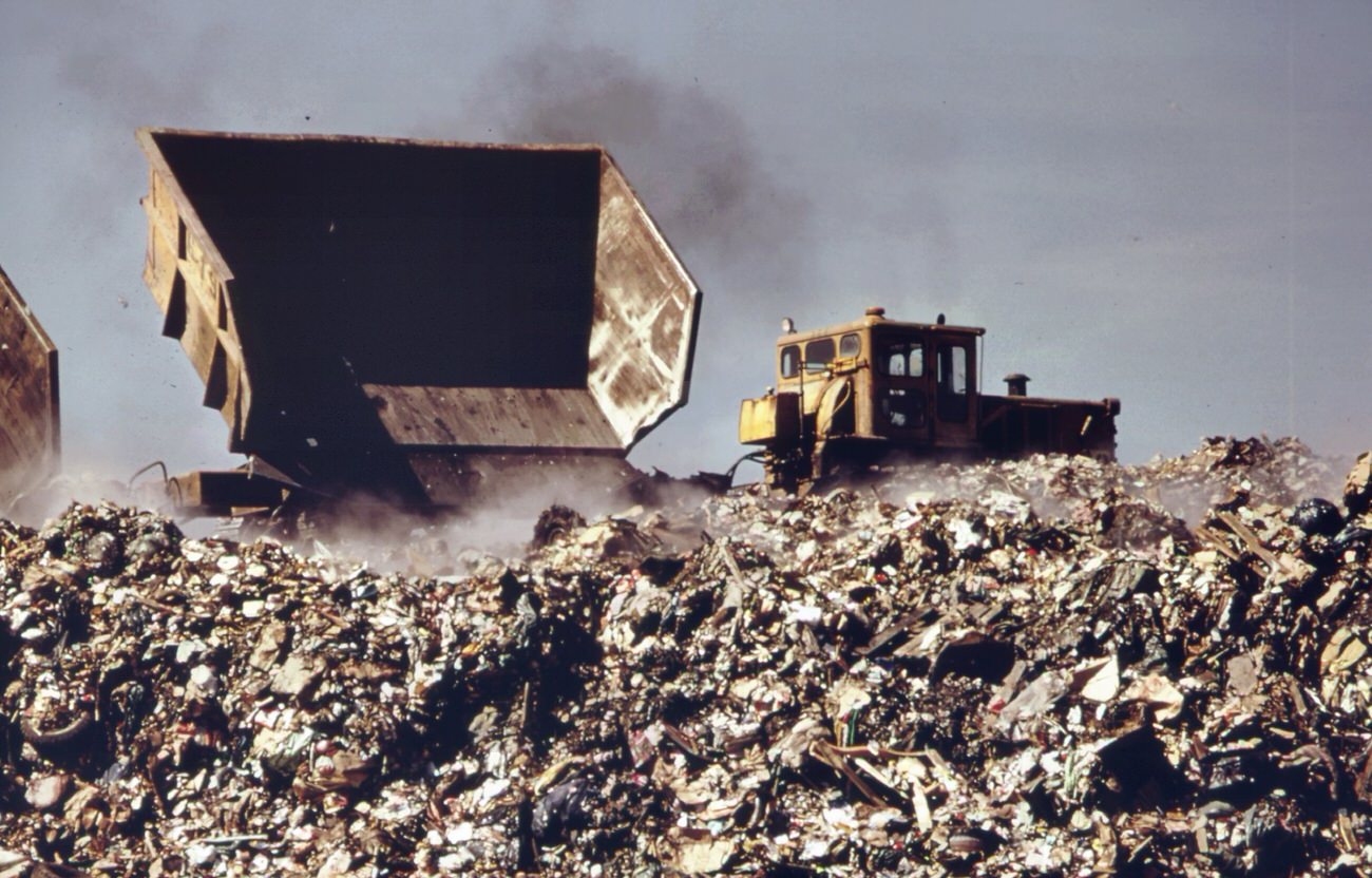 At staten island landfill. Garbage brought by barge from manhattan is dumped at outer edges of landfill area, 1970s