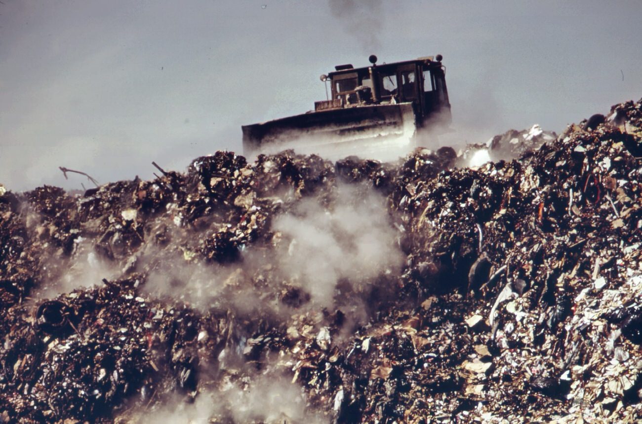 At staten island landfill. Garbage brought by barge from manhattan is dumped at outer edges of landfill area, 1970s