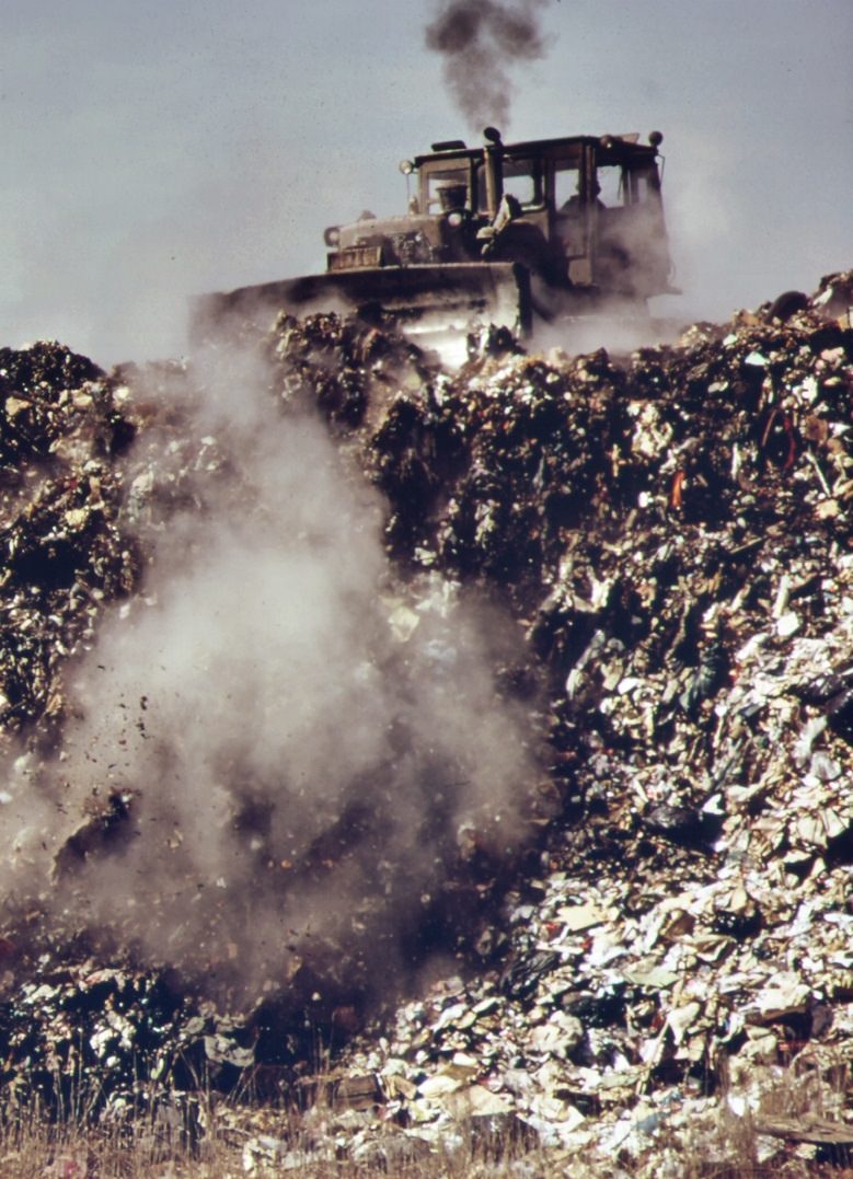 At staten island landfill. Garbage brought by barge from manhattan is dumped at outer edges of landfill area, 1970s