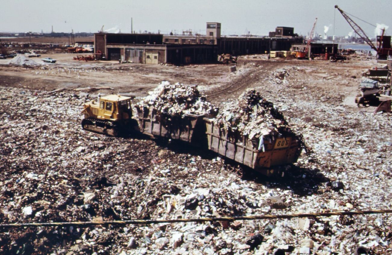 The landfill at staten island exceeds its capacity. Overflow of waste into surrounding land and water is a result, 1970s