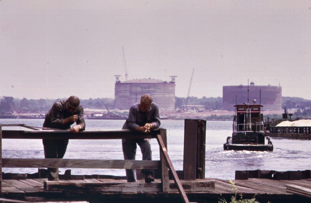 The texas eastern gas tank (in background) on staten island as seen from the opposite side of arthur kill at port reading, 1970s