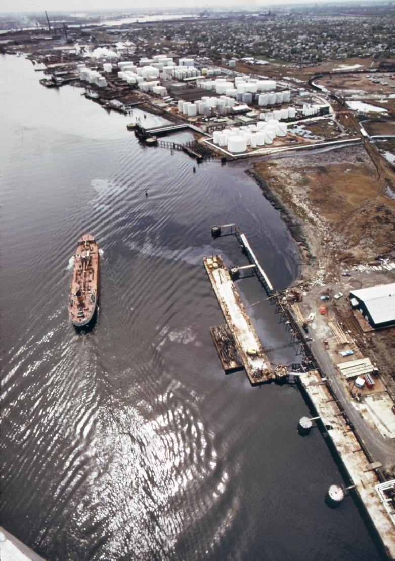 Oil tankers provide storage for a large variety of chemicals on arthur kill, the waterway which separates new jersey and staten island, 1970s
