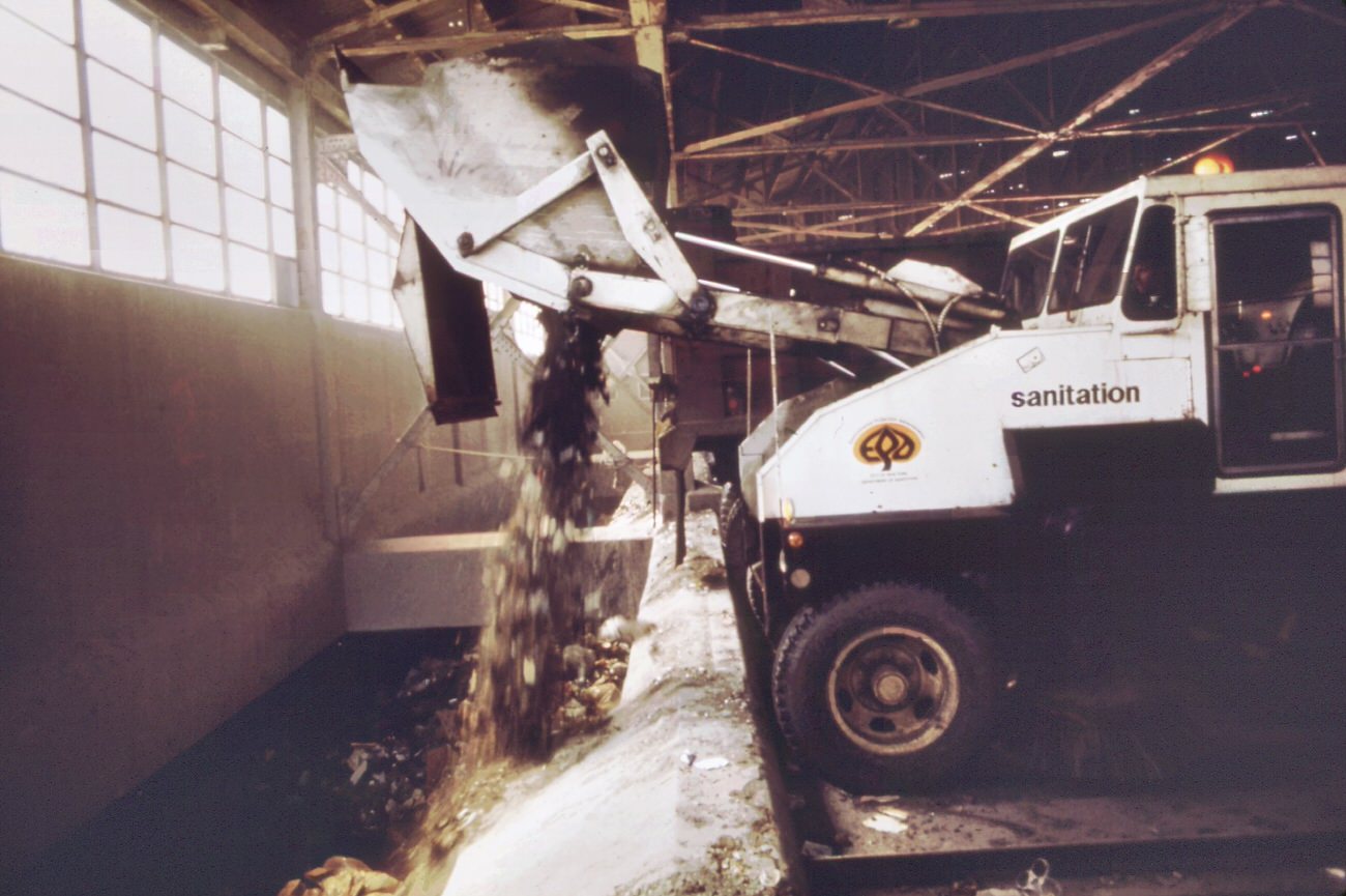 Garbage trucks at 91st street marine transfer station. From this point, barges carry wastes down the east river to the staten island landfill, 1970s