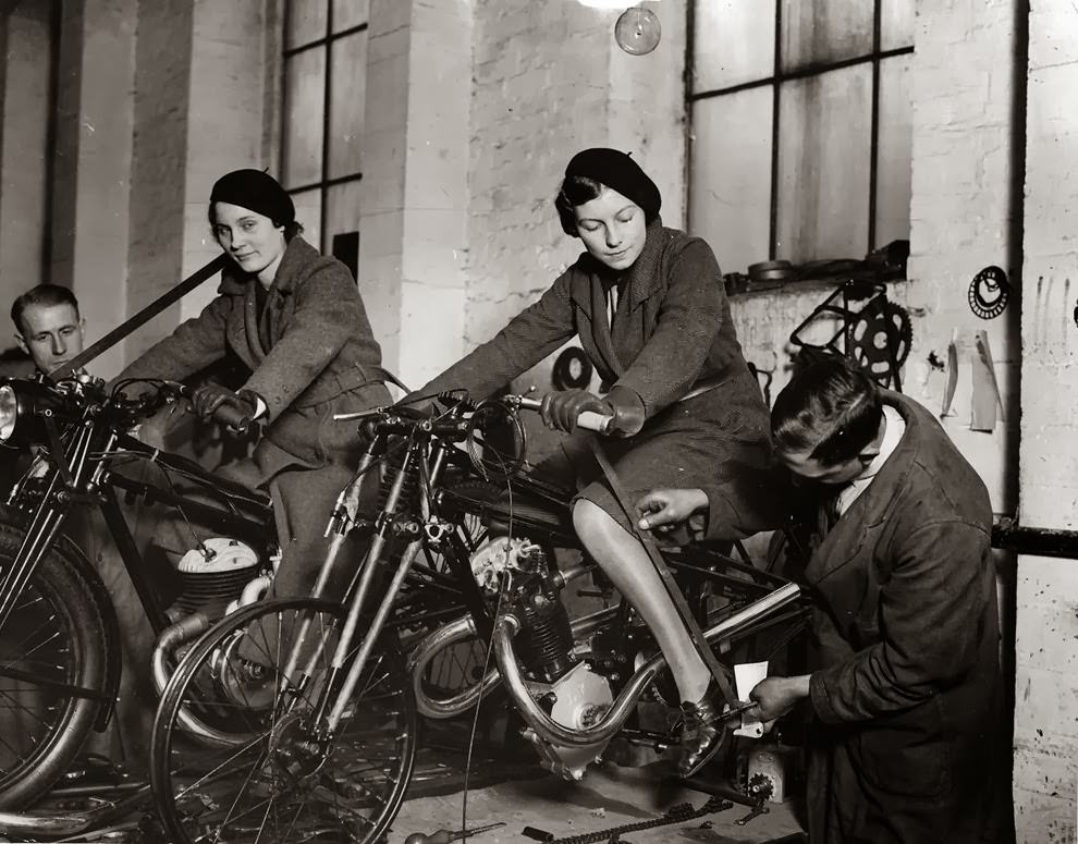 Workers measuring the positions of footrests and controls on partially finished motorcycles, 1933.