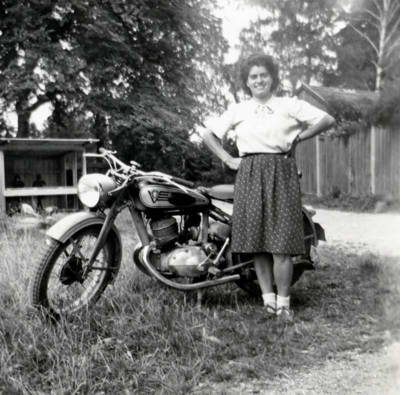 A young brunette lady proudly posing with a victoria kr 20 en in summertime, circa 1938.