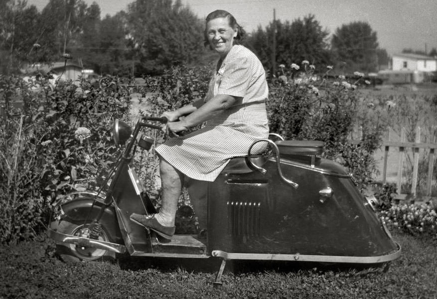 A woman on the cushman motorcycle